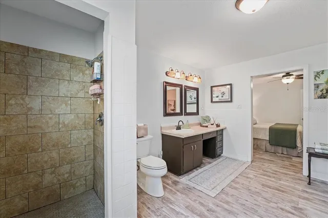 a view of a hallway with a livingroom and dinning room with furniture