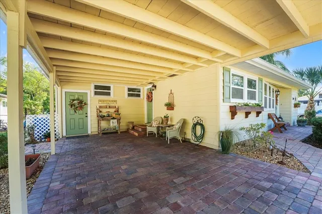 a view of a porch with chairs and plants