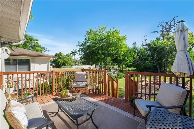 a view of a backyard with sitting area