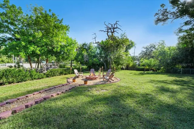 a view of a house with a backyard porch and sitting area