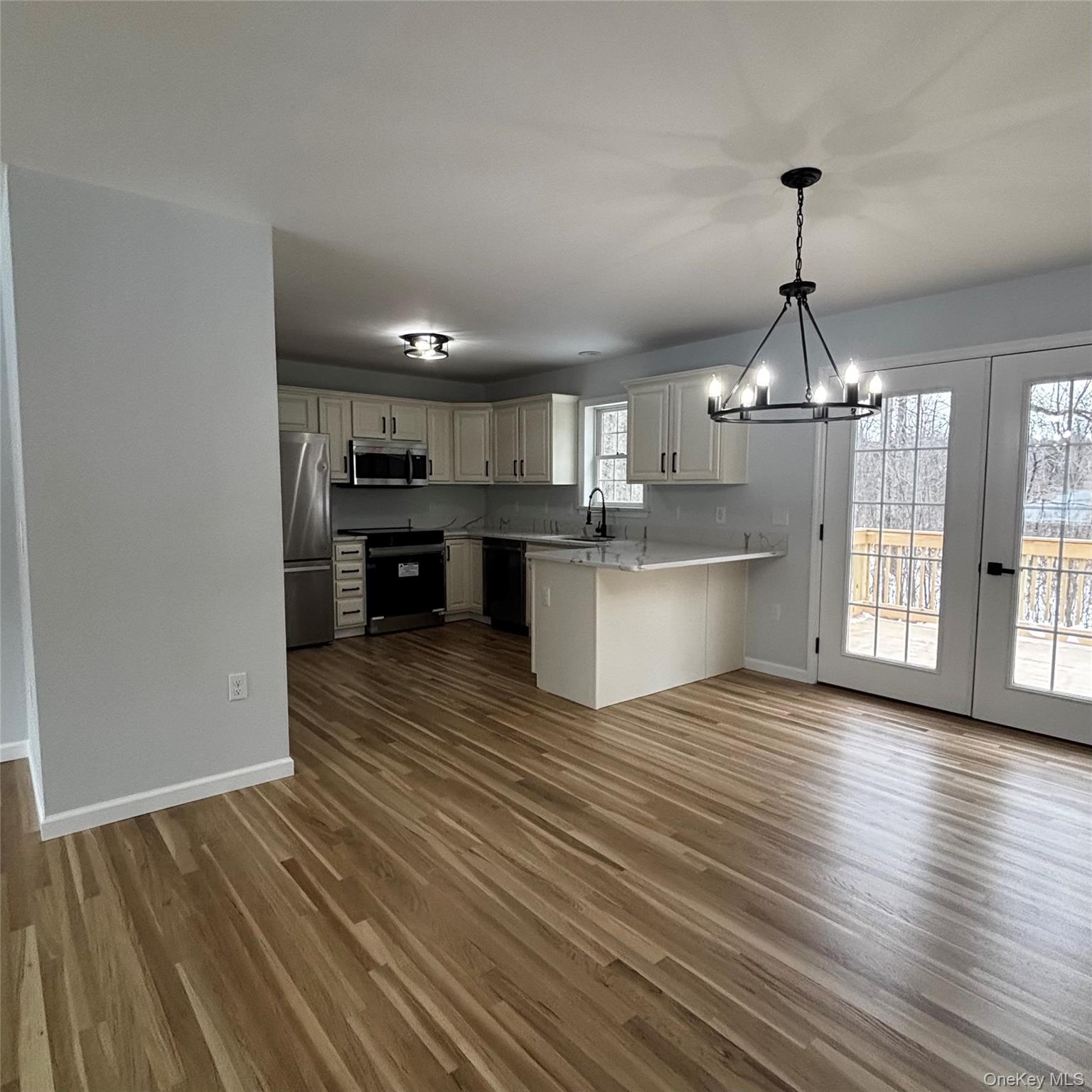 35 Pioneer Road Gardiner, NY 12525 - Photo 1 of 1 Kitchen featuring open floor plan, light countertops, black appliances, a chandelier, and a peninsula