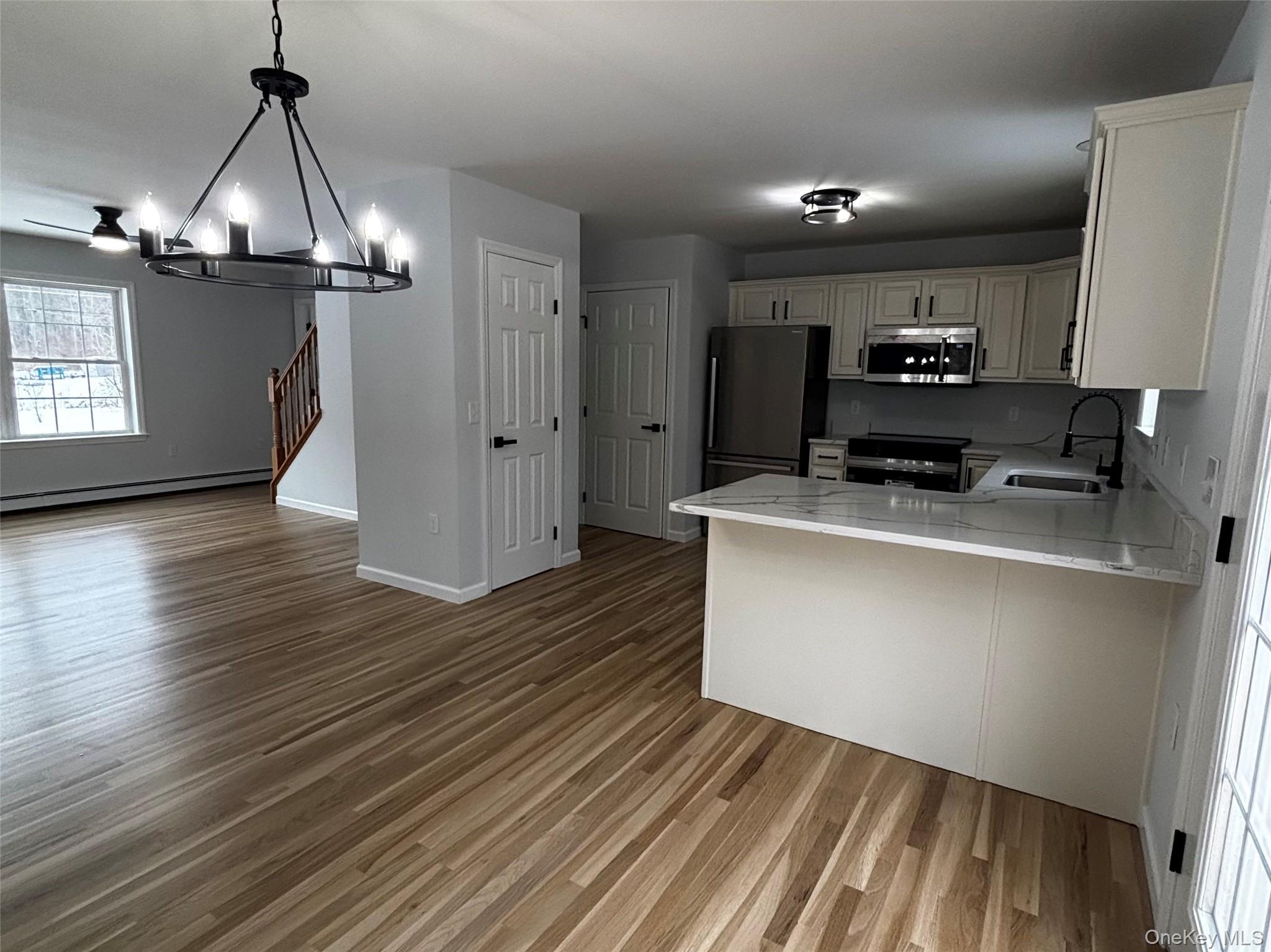 35 Pioneer Road Gardiner, NY 12525 - Photo 42 of 44 a kitchen with kitchen island stainless steel appliances a wooden floor stove and a window