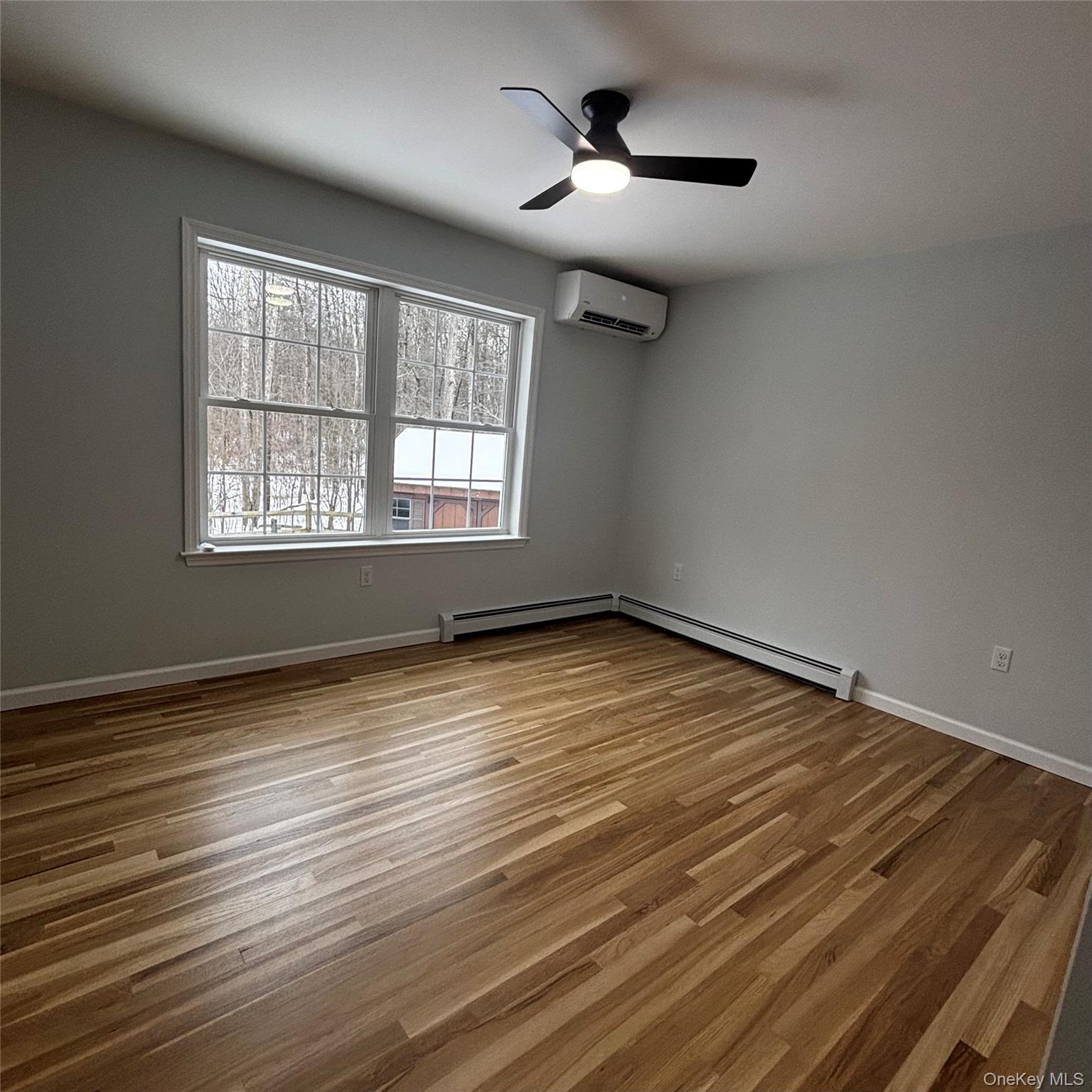 35 Pioneer Road Gardiner, NY 12525 - Photo 27 of 44 an empty room with wooden floor and windows