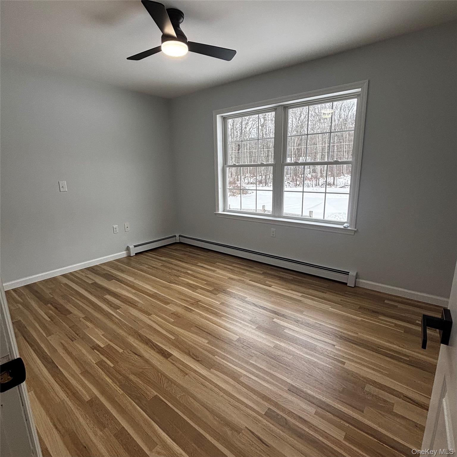 35 Pioneer Road Gardiner, NY 12525 - Photo 28 of 44 an empty room with wooden floor and windows