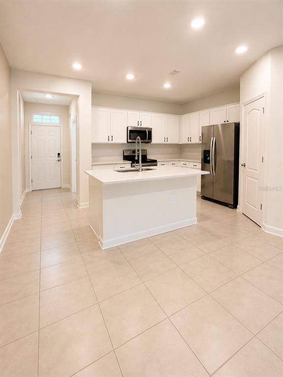 339 Redbud Road Palm Coast, FL 32137 - Photo 6 of 22 a view of kitchen with stainless steel appliances granite countertop a sink and cabinets