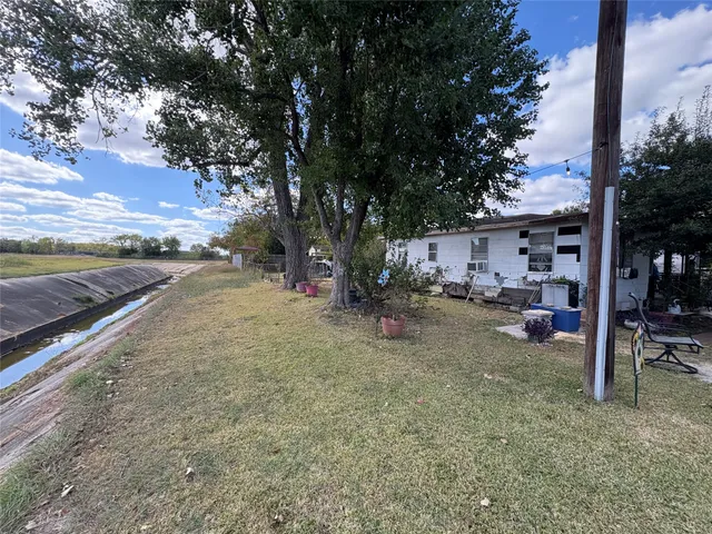 a view of a yard with a tree