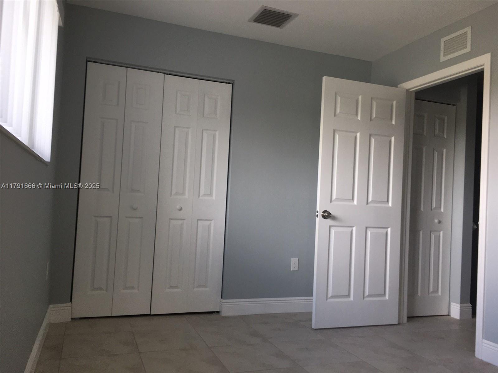 1990 Northwest 4th Court, Unit 8 Miami, FL 33136 - Photo 12 of 19 an empty room with windows
