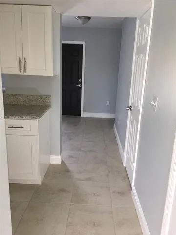 a bathroom with a granite countertop bathtub shower and toilet