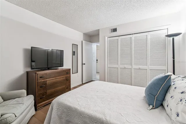 a bedroom with a bed and a television