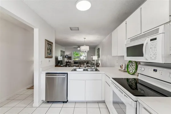 a kitchen with a sink a stove and cabinets
