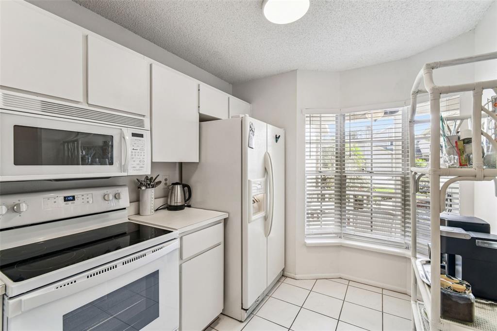 6531 Remus Drive New Port Richey, FL 34653 - Photo 16 of 39 a kitchen with a stove and a microwave