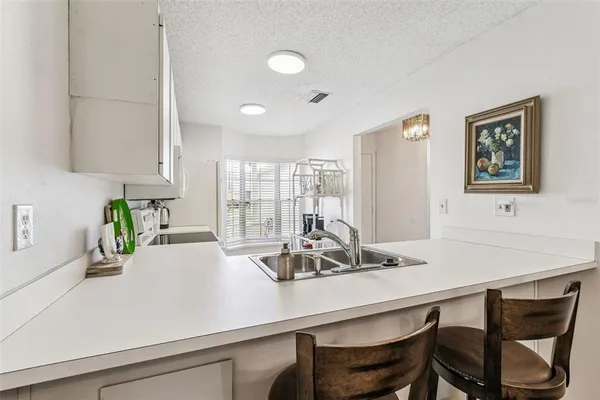 a kitchen with a table and chairs