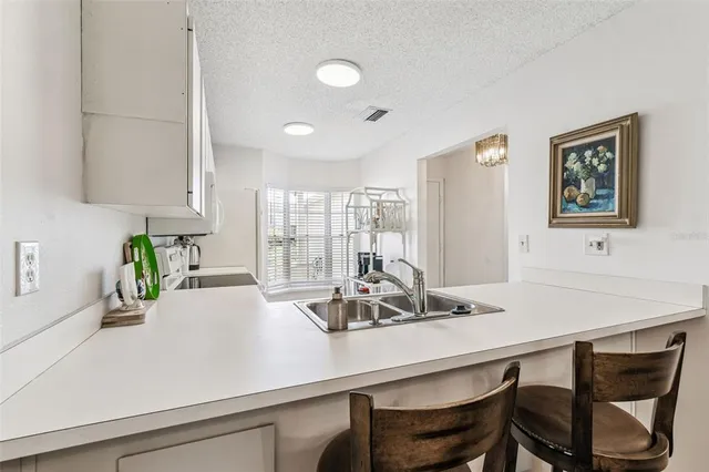 a kitchen with a table and chairs