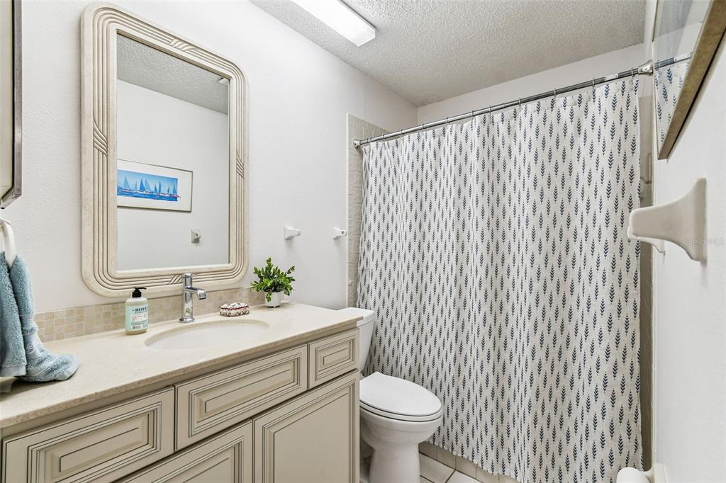 6531 Remus Drive New Port Richey, FL 34653 - Photo 19 of 39 a bathroom with a sink a toilet and mirror