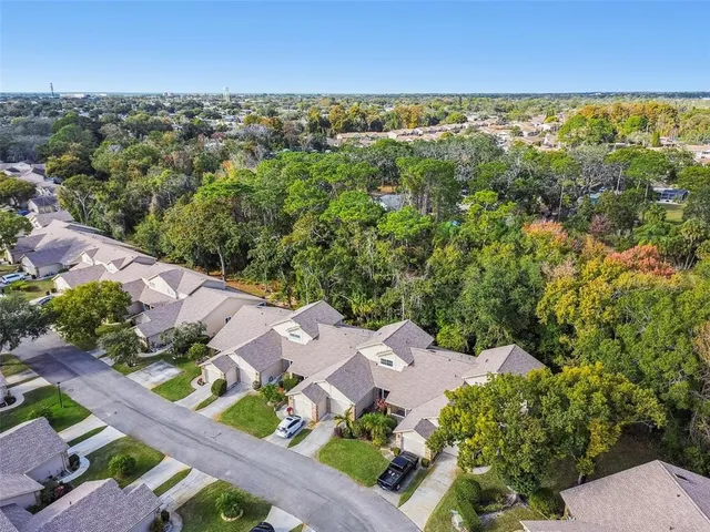 an aerial view of residential houses with outdoor space and street view