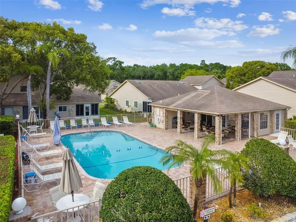 a view of house with garden and tall trees