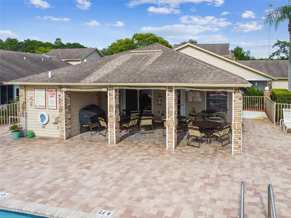 a view of house with yard and sitting area