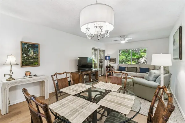 a view of a dining room with furniture a livingroom and chandelier