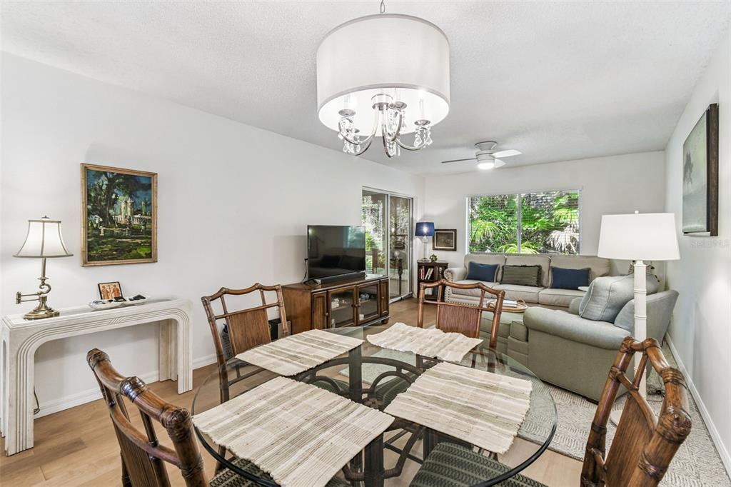 6531 Remus Drive New Port Richey, FL 34653 - Photo 6 of 39 a view of a dining room with furniture a livingroom and chandelier