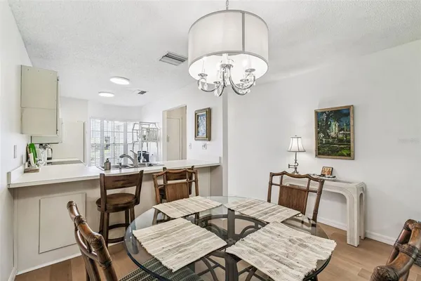 a view of a dining room with furniture wooden floor and chandelier