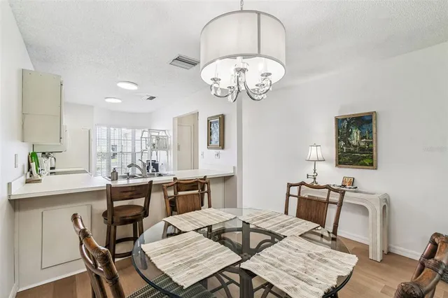 a view of a dining room with furniture wooden floor and chandelier