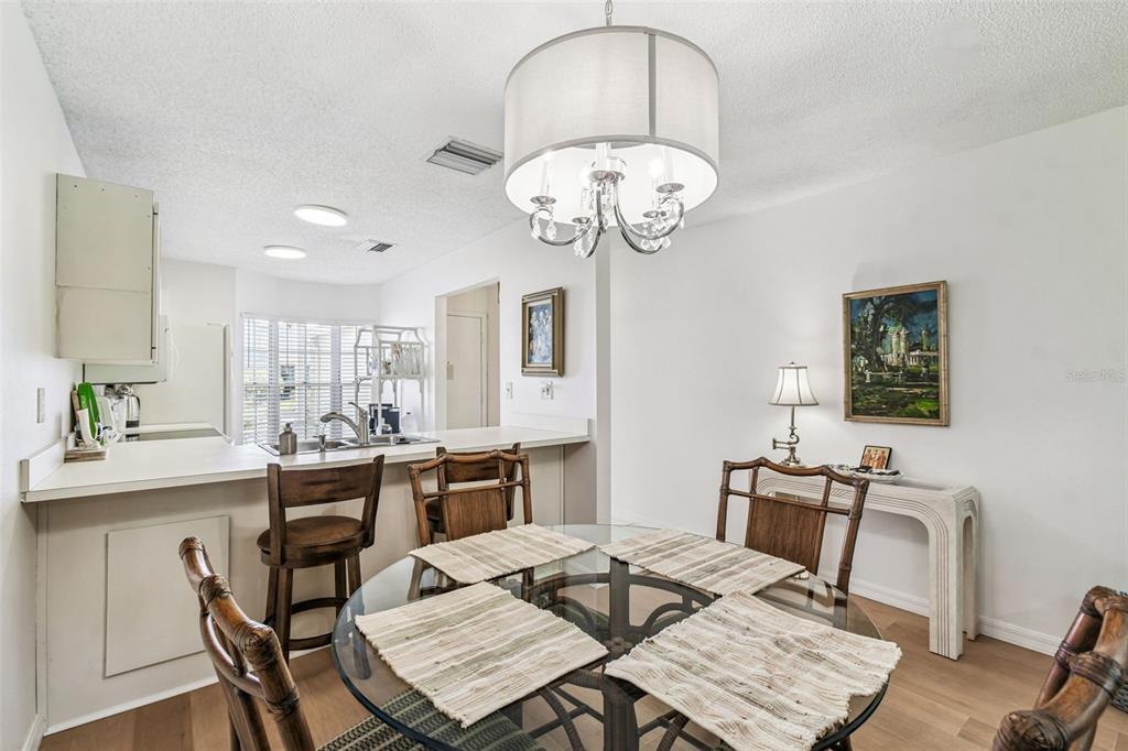 6531 Remus Drive New Port Richey, FL 34653 - Photo 7 of 39 a view of a dining room with furniture wooden floor and chandelier