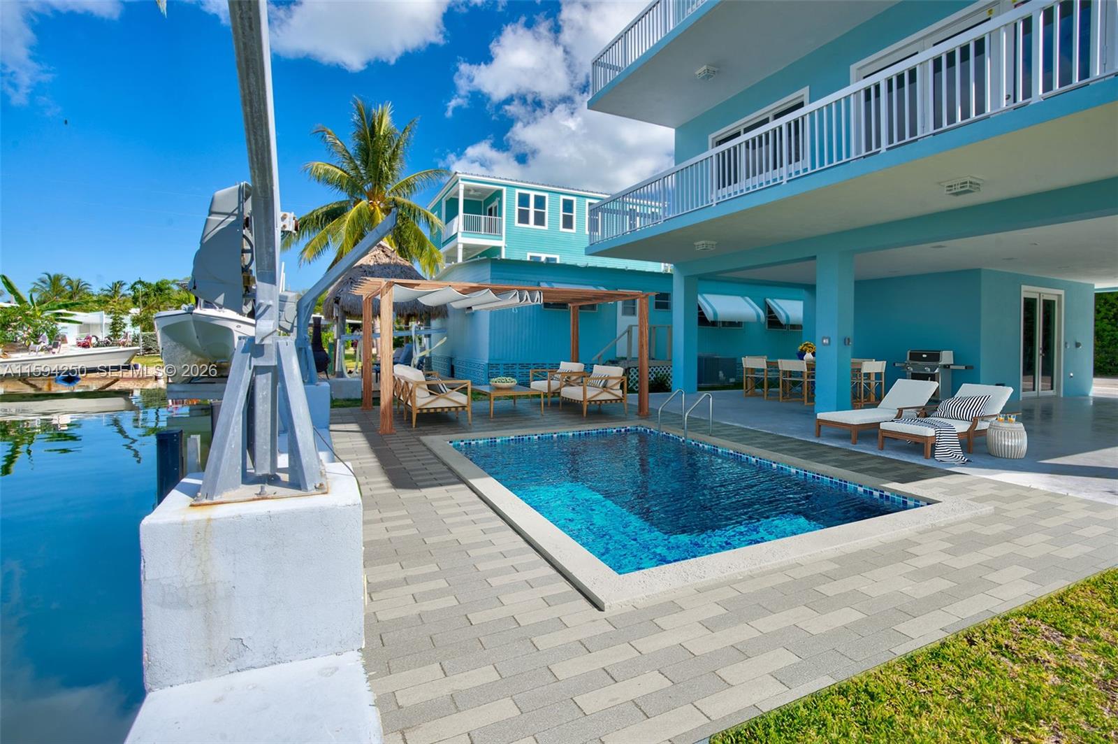 84 Coral Way Key Largo, FL 33037 - Photo 39 of 55 a view of a swimming pool with outdoor seating
