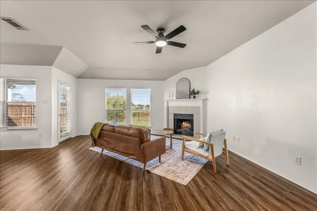 a living room with furniture and a fireplace