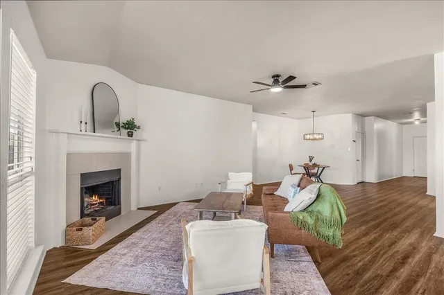 a living room with lots of furniture and view of kitchen