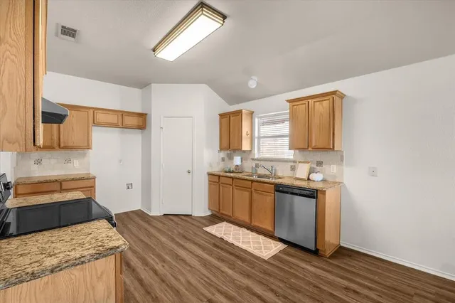 a kitchen with a sink stove and refrigerator