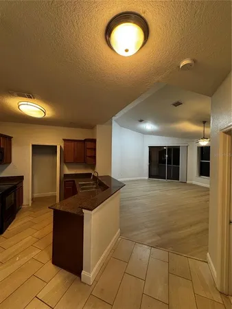 a kitchen with kitchen island granite countertop a stove and a sink
