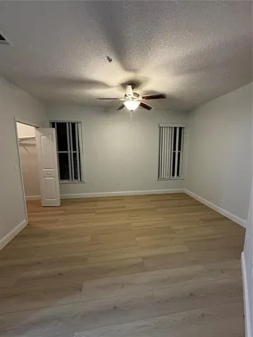 a bathroom with a granite countertop toilet sink and mirror
