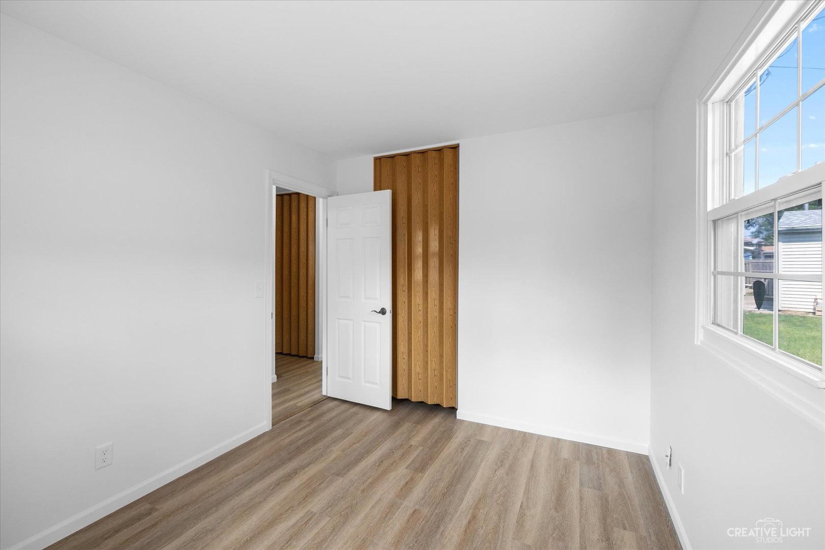 42 Hampton Road Montgomery, IL 60538 - Photo 15 of 26 an empty room with wooden floor and windows