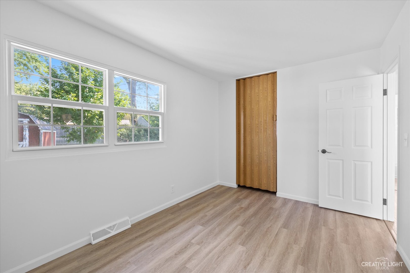 42 Hampton Road Montgomery, IL 60538 - Photo 17 of 26 a view of empty room with wooden floor and fan
