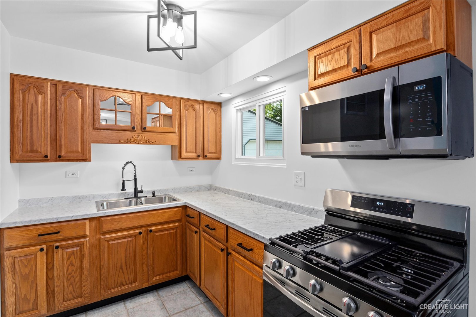 42 Hampton Road Montgomery, IL 60538 - Photo 10 of 26 a kitchen with stainless steel appliances granite countertop a stove and a microwave