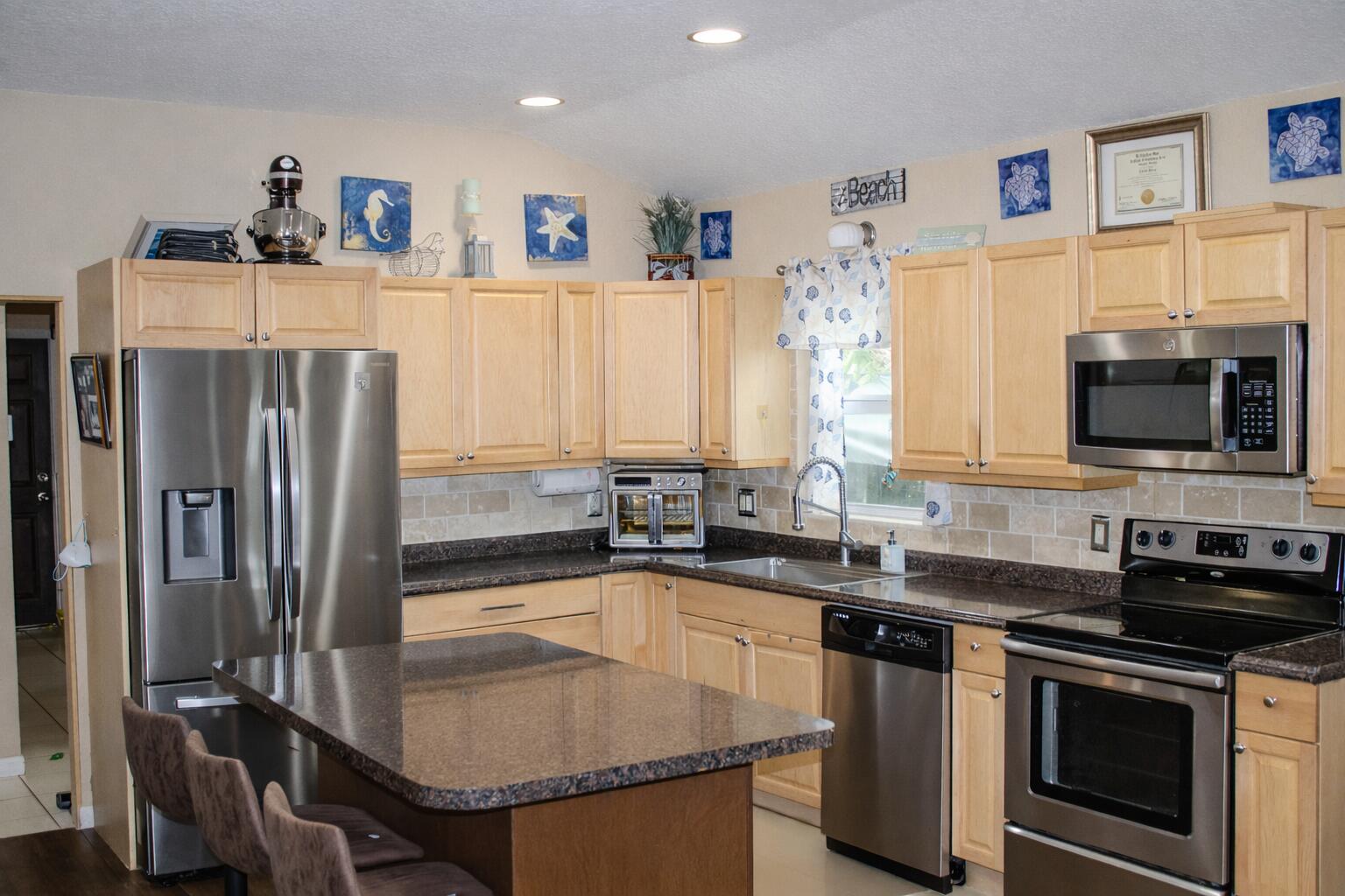 711 Sharon Place Key Largo, FL 33037 - Photo 11 of 38 a kitchen with stainless steel appliances a sink stove and refrigerator