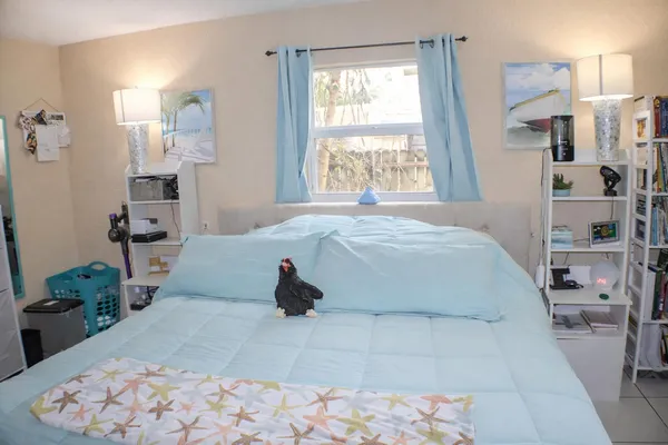 a bedroom with a bed and a large mirror