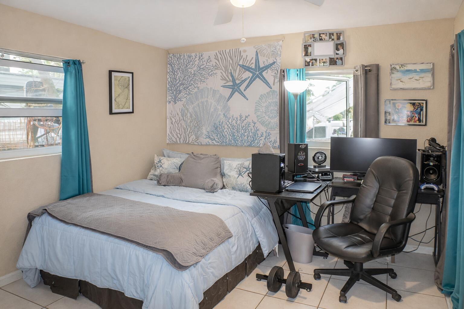 711 Sharon Place Key Largo, FL 33037 - Photo 16 of 38 a bedroom with a bed and a couch