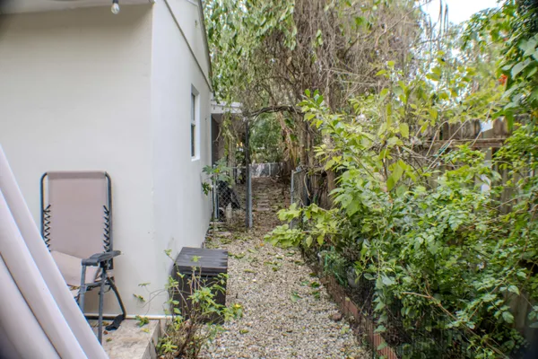 a backyard of a house with a garden and plants