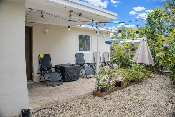 a view of a porch with potted plants