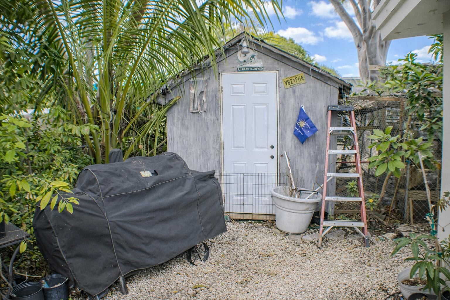 711 Sharon Place Key Largo, FL 33037 - Photo 31 of 38 a view of a chair and table in the backyard