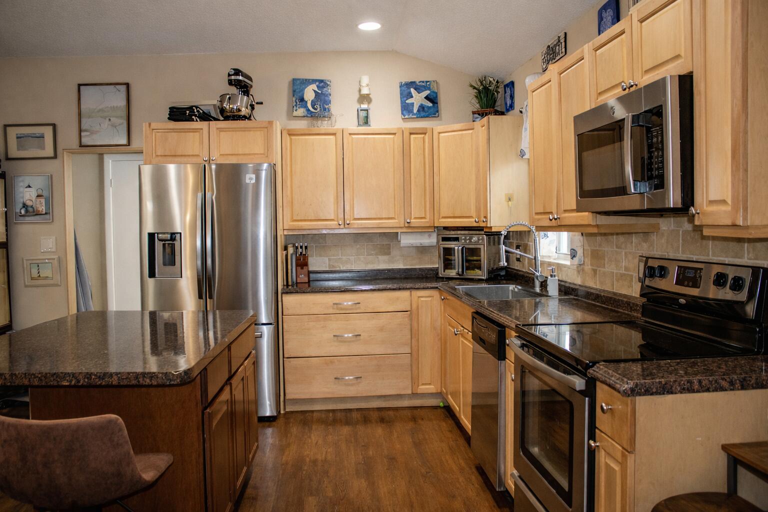 711 Sharon Place Key Largo, FL 33037 - Photo 8 of 38 a kitchen with granite countertop a refrigerator stove and sink