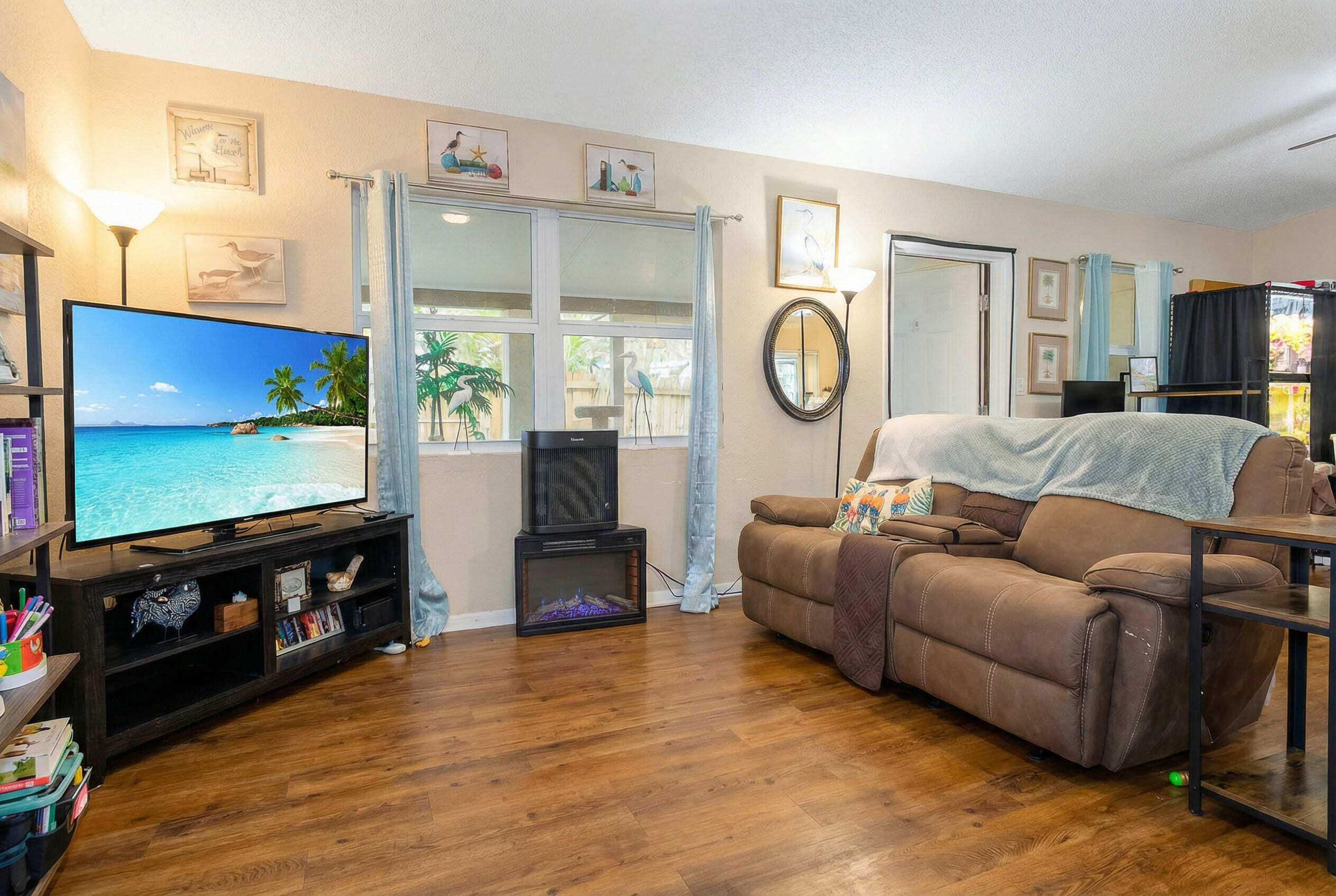 711 Sharon Place Key Largo, FL 33037 - Photo 9 of 38 a living room with furniture a flat screen tv and a fireplace