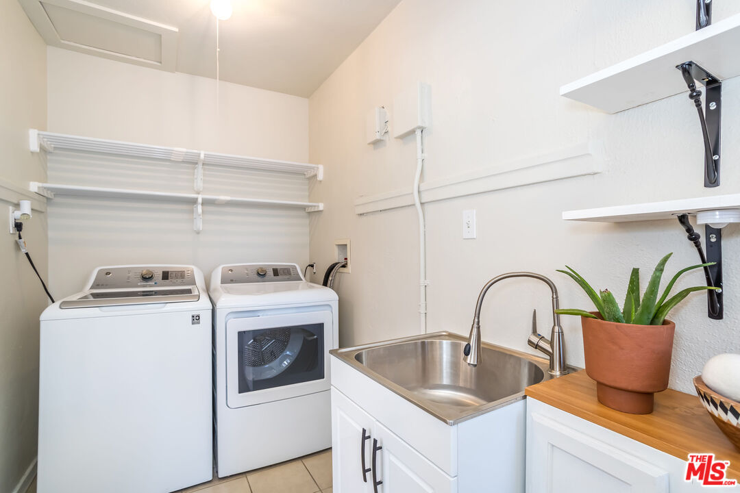 2850 Buckingham Road Los Angeles, CA 90016 - Photo 17 of 34 a kitchen with a stove a sink and white cabinets