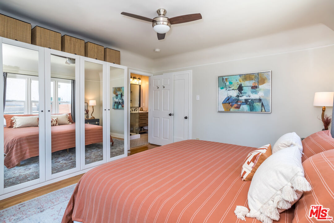 2850 Buckingham Road Los Angeles, CA 90016 - Photo 20 of 34 a bedroom with a large bed and a chandelier