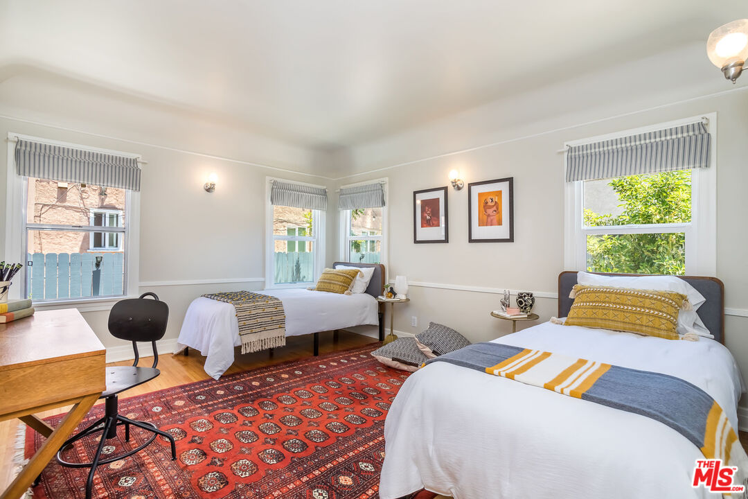 2850 Buckingham Road Los Angeles, CA 90016 - Photo 23 of 34 a bedroom with two beds and a large window