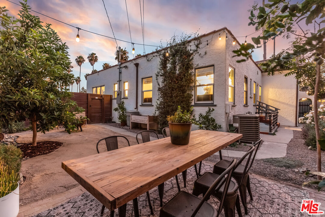2850 Buckingham Road Los Angeles, CA 90016 - Photo 29 of 34 a view of a patio with a table and chairs and potted plants