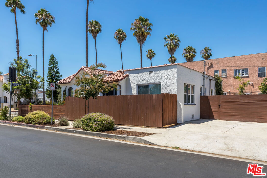 2850 Buckingham Road Los Angeles, CA 90016 - Photo 33 of 34 a front view of a house with a yard and garage