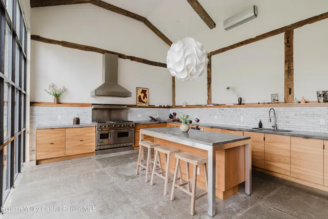 a spacious bedroom with a bed and a dresser in it