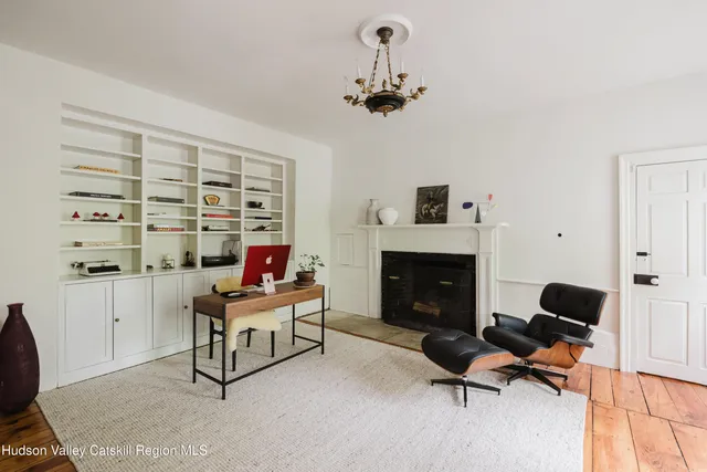 a bathroom with a granite countertop sink a mirror and shower